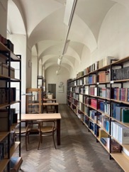 Photograph of shelves, books and desks of The Library of the National Gallery, Prague